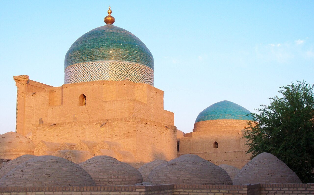 Pahlavon Mahmud Mausoleum domes at sunset in Khiva
